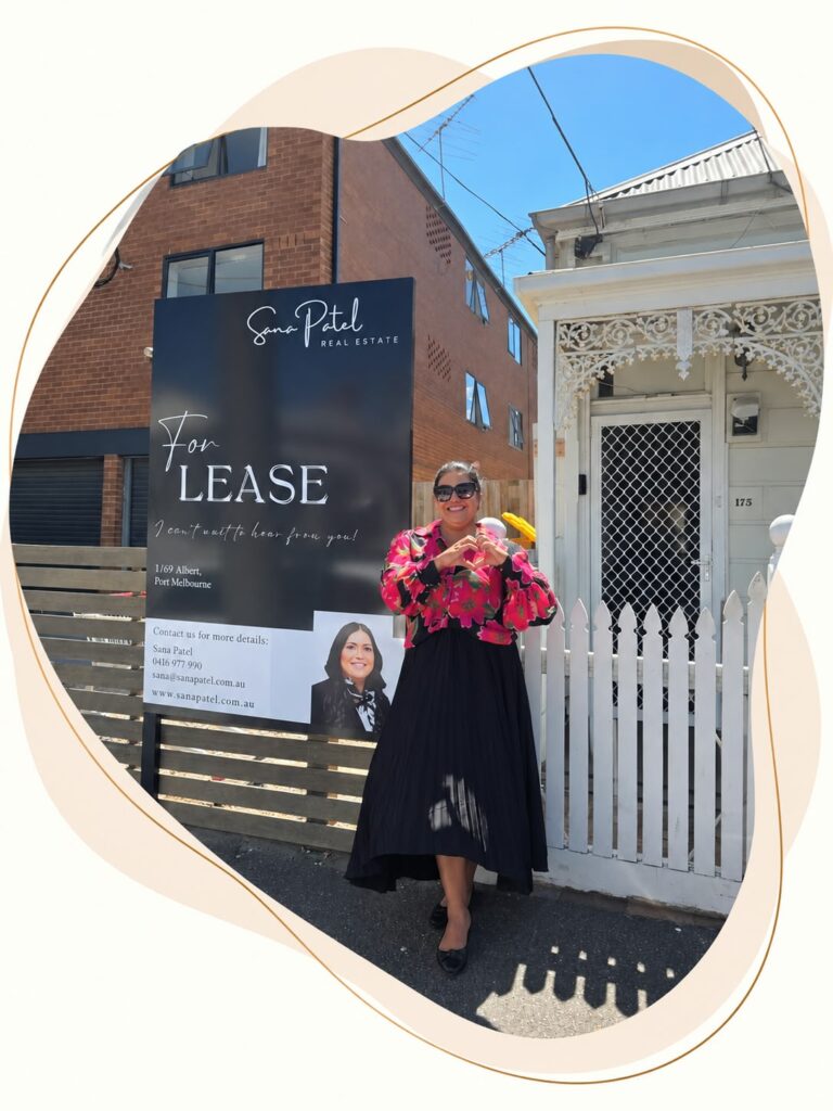 Sana Patel beside a Sana Patel Real Estate For Lease sign in Port Melbourne